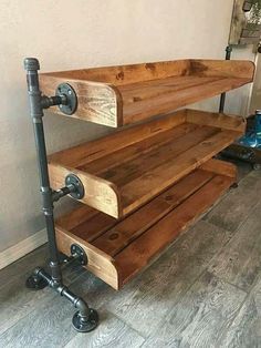 an industrial style wooden shelf with pipe handles