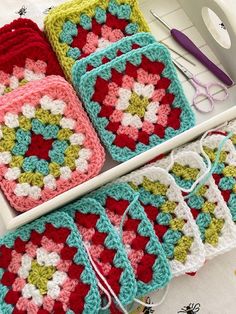 crocheted grannys are arranged on a table