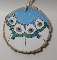 a wooden ornament with three polar bears on it