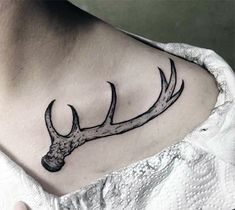 a deer's head with antlers on the chest