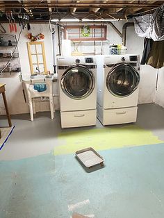 a washer and dryer sitting in a room next to each other on the floor