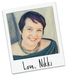 a woman with purple hair wearing a green dress and smiling at the camera, in front of a white background that says love, nik