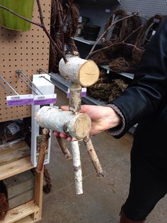 a person holding a piece of wood in their hand