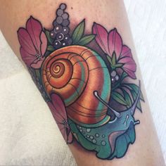 a colorful snail tattoo on the leg