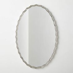 a round mirror hanging on the wall