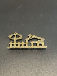 two brass colored house and tree hooks