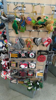 there are many items on the rack in this store that is selling souvenirs