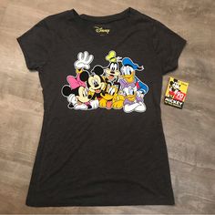 a black shirt with mickey mouse and friends on it