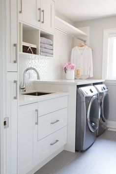 a washer and dryer in a white laundry room