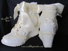 a pair of white wedding shoes with bows