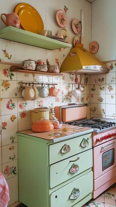 a green stove top oven sitting inside of a kitchen next to a wall covered in plates