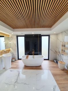 a large white bath tub sitting inside of a bathroom