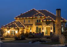 a house decorated with christmas lights and decorations