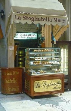 a pastry shop with an awning over it's front door and sign for la stogitatella mary