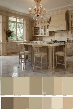 a large kitchen with lots of white cabinets and chandelier hanging from the ceiling