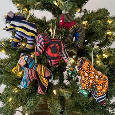 an ornament is hanging from a christmas tree decorated with mittens and gloves