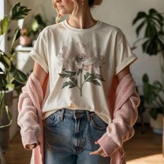 This botanical anemone flower t-shirt exudes a fresh and natural vibe, perfect for nature lovers and flower enthusiasts. It is versatile for everyday wear and can be dressed up or down for different occasions. Ideal for casual outings, nature walks, and gardening enthusiasts. Product features - Made with 100% lightweight cotton for breathability and easy layering - Retail fit for casual and semi-formal settings - Sustainably manufactured by Bella+Canvas in the US and internationally - Ribbed knit collar with seam for shape retention - Shoulder tape for added garment stability Care instructions - Machine wash: cold (max 30C or 90F) - Non-chlorine: bleach as needed - Tumble dry: low heat - Iron, steam or dry: medium heat - Do not dryclean Feminine Relaxed Fit T-shirt For Spring, Pink Organic Cotton Tops For Spring, Spring Pink Organic Cotton Tops, Pink Organic Cotton T-shirt For Spring, Casual Spring Tops With Birth Flower Design, Everyday Floral Print Crew Neck Top, Floral Print Crew Neck Top, Casual Crew Neck T-shirt With Birth Flower, Casual Birth Flower Crew Neck T-shirt