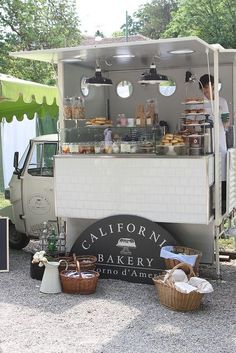 a food cart with donuts and other items on display