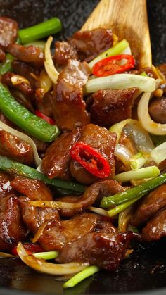 the stir fry has meat, onions and peppers in it