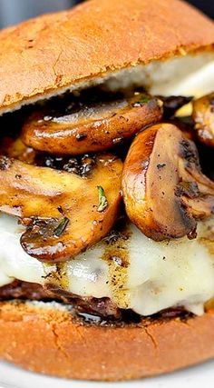 a close up of a sandwich with mushrooms on it