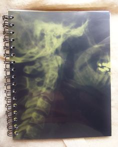 a spiral notebook with green ink on it