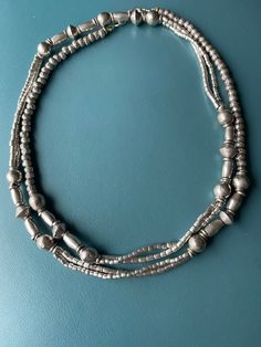 Ethiopian, Channel type necklace. Made up of antique,good silver Kaffa/Jimma beads, prayer beads, and sterling Asian beads, timeless charm. The silver is high quality of 835-870 silver and the back done with the Asian Sterling beads. The beads used from Ethiopia are antique 1920s about. They are now hard to find as they were already hard to find in EThiopia sinds the 1982. What they are producing now is brass plate and do not have the warmth of these beads. Handmade and weighty beads. Worked fro Brass Plate, Silver Chain Style, Beads Handmade, Lovely Necklace, Prayer Beads, Shiny Silver, Ethiopia, Chain Styles, Silver Beads