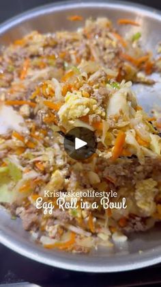 an egg roll in a bowl with carrots and celery on it is being stirred by a spoon