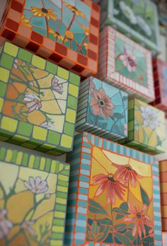 many colorful tiles with flowers painted on them