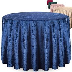 two round tables with blue and gold tablecloths on them next to each other