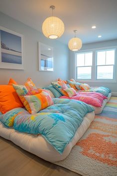 a room that has many pillows on the floor and in front of it is a large bed