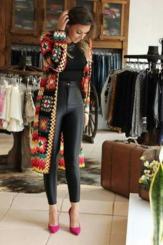 a woman standing in front of a clothing rack