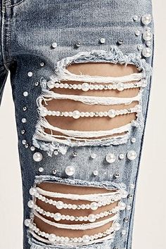 the back of a woman's jeans with pearls on it