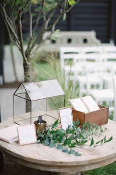 the table is set up with cards and place settings for guests to sit down at