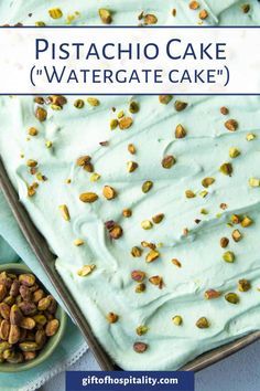 pistachio cake with white frosting and pistachio nuts