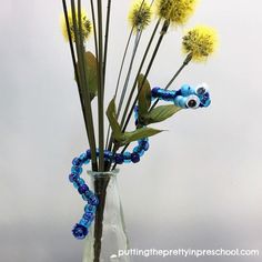 a vase filled with yellow and blue flowers