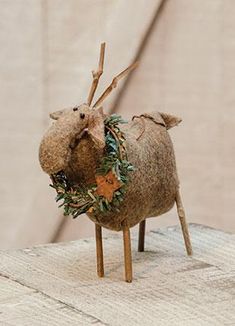 an animal made out of wood and decorated with greenery