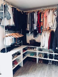 an organized closet with clothes and shoes