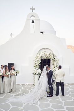 the bride and groom are getting ready to walk down the aisle at their wedding ceremony