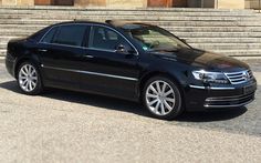 a black car parked in front of some steps