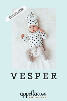 a baby laying on top of a bed wearing a white and black hat with the words vesper appellation above it