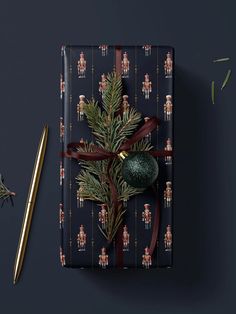 a present wrapped in wrapping paper with a christmas tree decoration