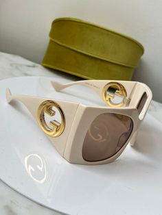 Brand new Gucci GG1255S 002 Ivory White Sunglasses. Ultra oversized ivory mask sunglasses in with large gold cutout emblems on temples. Dark brown lens. Limited Edition. Size 64-20-125. Retail $655. Comes with Gucci jewel toned velvet case, cleaning cloth, satin pouch and authenticity cards. 100% authentic. Made in Japan. Designer Beige Sunglasses With Gradient Lenses, Designer Beige Sunglasses With Tinted Lenses, Luxury Cream Sunglasses For Summer, Luxury Beige Sunglasses, Gucci Designer Shield Sunglasses With Uv Protection, Luxury Cream Sunglasses With Gradient Lenses, Luxury Beige Sunglasses With Gradient Lenses, Gucci Beige Tinted Sunglasses, Gucci White Sunglasses With Uv Protection