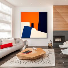 a living room filled with furniture and a large painting on the wall over a fire place