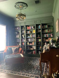 a living room filled with lots of furniture and bookshelves next to a window