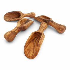 four wooden spoons sitting on top of each other in the shape of paddles