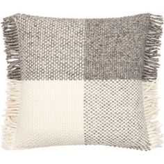 a gray and white checkered pillow with fringes on the front, in grey and white