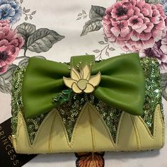 a purse with a green bow on it