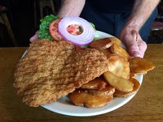 a plate with fried chicken, onion rings and lettuce