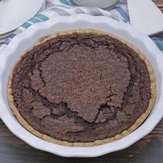 a chocolate pie sitting on top of a wooden table