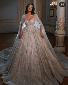 a woman in a gown standing on a wooden floor